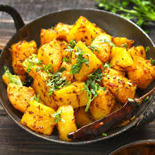 food culture “Spicy Pahadi Aloo Ke Gutke cooked in mustard oil, representing Uttarakhand’s authentic flavors.